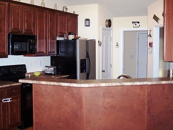 Large kitchen with pantry and raised eating bar.