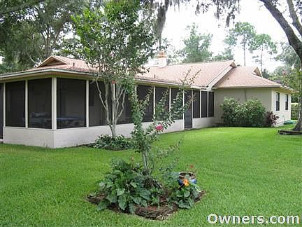 View of the back of the home showing the screened lanai