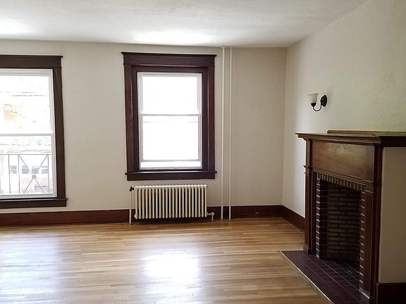 Large living room with hardwood floors and natural light