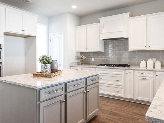 Belleview kitchen appointed with beautiful quartz countertops and white cabinets - Model Representa