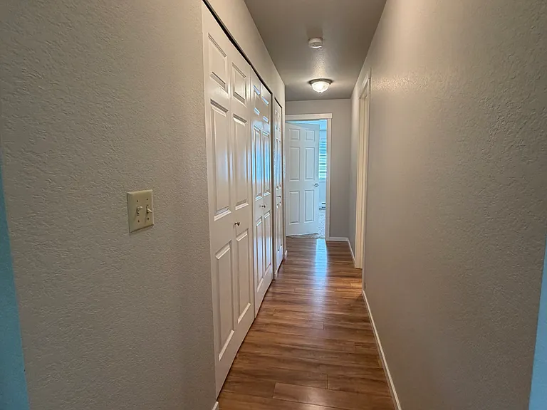 hall with laundry room on left