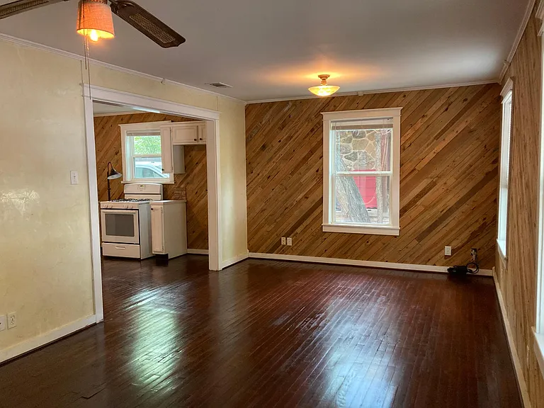 Living room with view of entry to kitchen