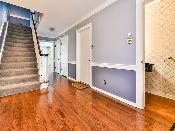 Entryway with hardwood floors and powder room
