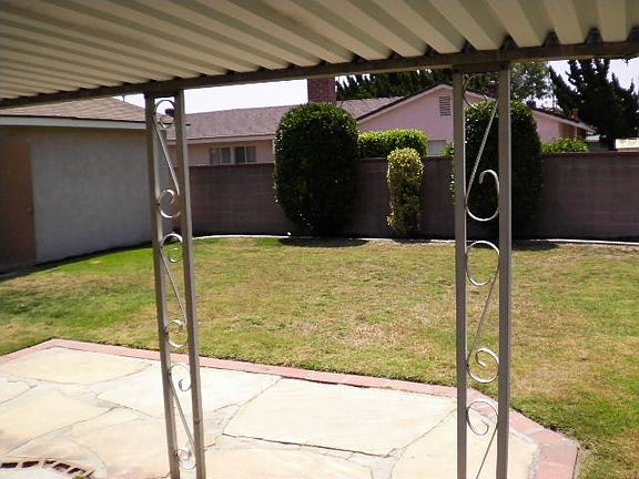 large backyard with covered patio