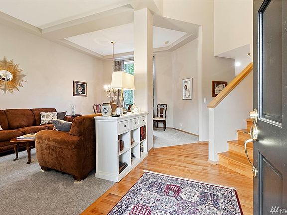 The home features an open entry with wood floor, large closet and built-in cabinet.