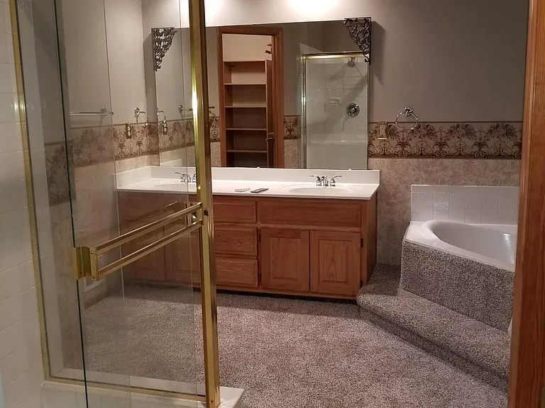 Master bathroom #1 - Shower, big tub and his & her sinks + storage. Toilet is in the room to the right.