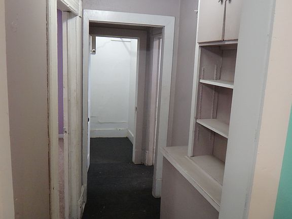 Hallway with shelf space, and a large walk in closet!