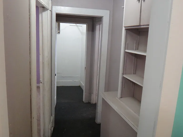 Hallway with shelf space, and a large walk in closet!