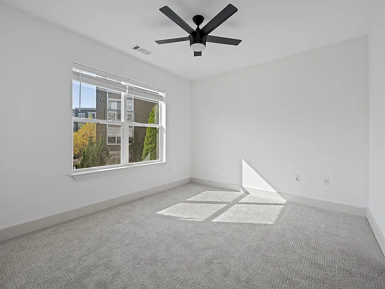 Spacious Bedroom with Carpet and Ceiling Fan and Outdoor Views