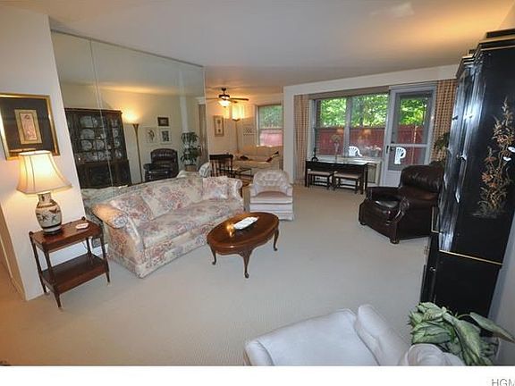 The large living room has a door leading to a private fenced in terraced/back yard. The living room 