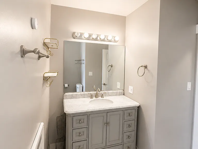 Large vanity with storage and updated fixtures.