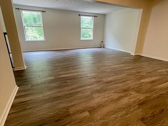Living and dining room with new wooden flooring.