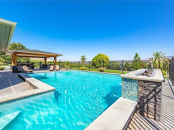 Easy entry to pool.  Completely fenced in and surrounded by a nice green belt of lawn.