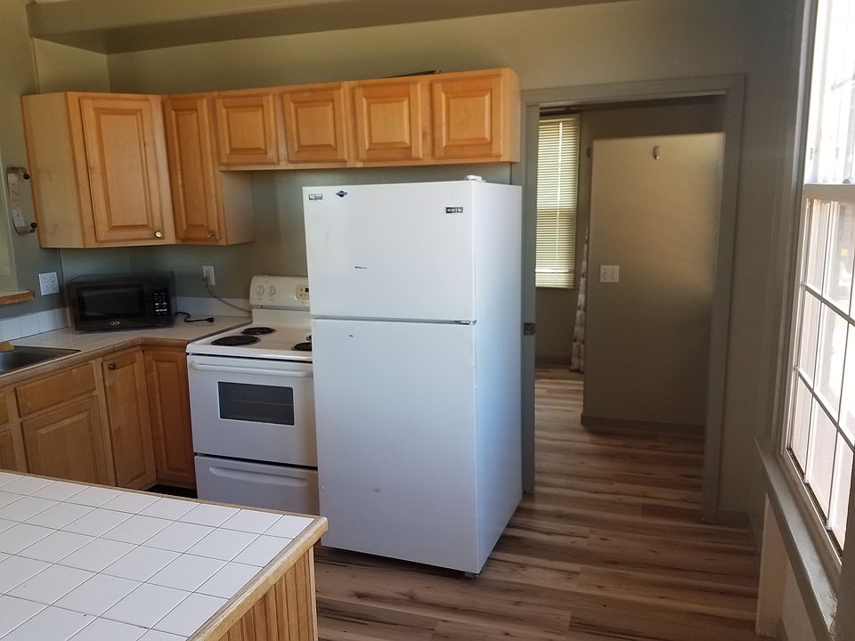 Looking through kitchen towards bathroom.