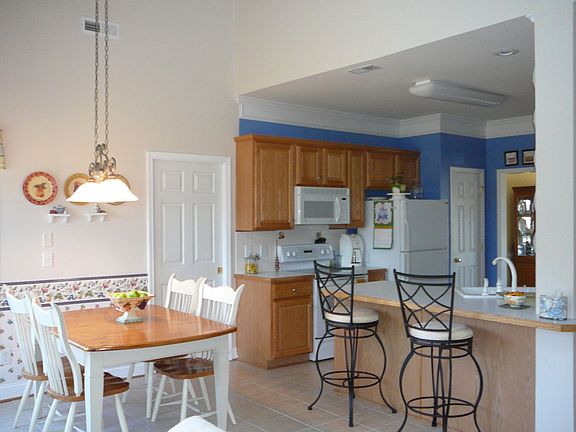 Bright open kitchen with breakfast bar and eat-in kitchen.