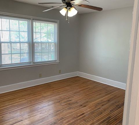 Primary Bedroom, Hardwood floors, Mini-blinds, ceiling fan.