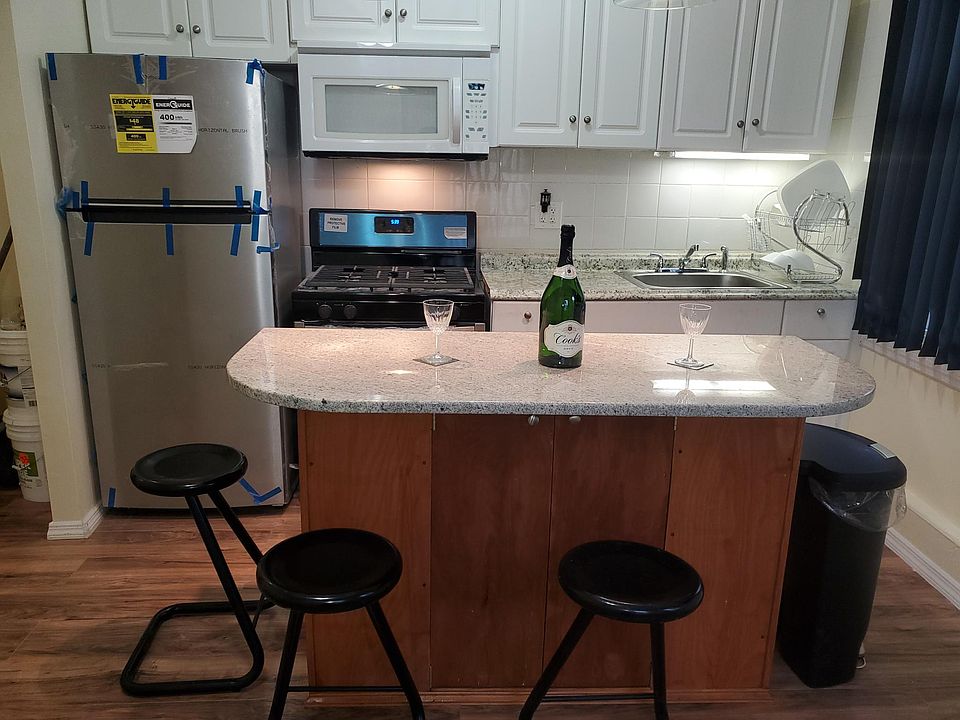 Kitchen area front view with new appliances Taken in front of centre island.