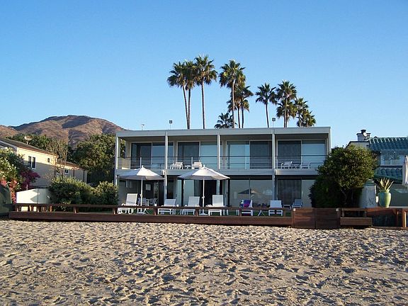 Exterior from expansive, dry, sandy beach