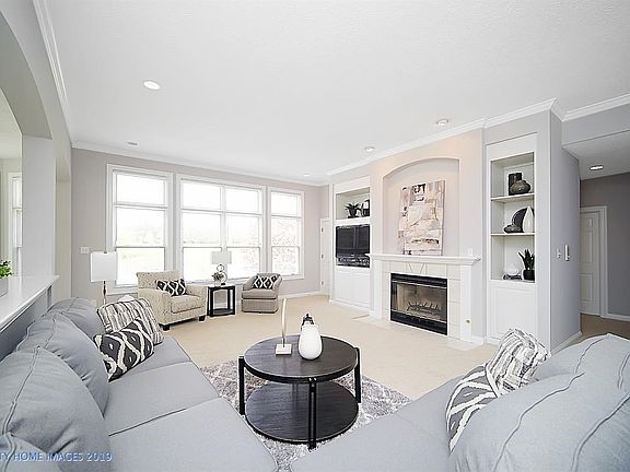 This freshly painted living room just glows with the natural lighting from the expansive windows overlooking the golf course.