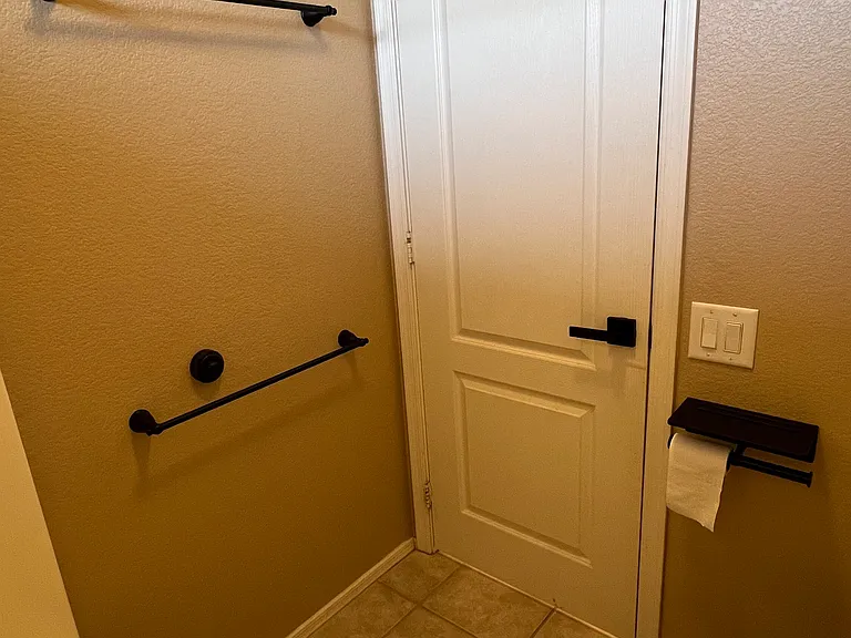 upstairs full bathroom toilet tub shower area with double towel bars, towel storage rack, 3 wall hooks, double toilet paper holder with wide shelf for phone to watch movies from tub