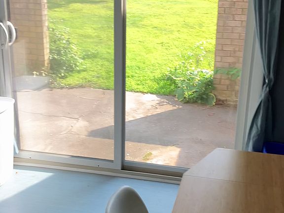 Patio doors leading to the shared outdoor space