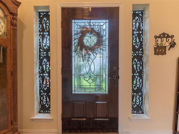 Beautiful leaded glass front door greets you at entry