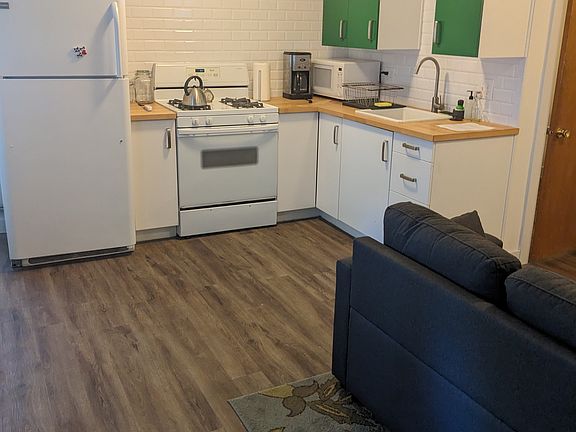 Galley Kitchen with full-sized refrigerator, gas range, sink and disposal. Full stocked with pots, pans, utensils, flatware, etc.