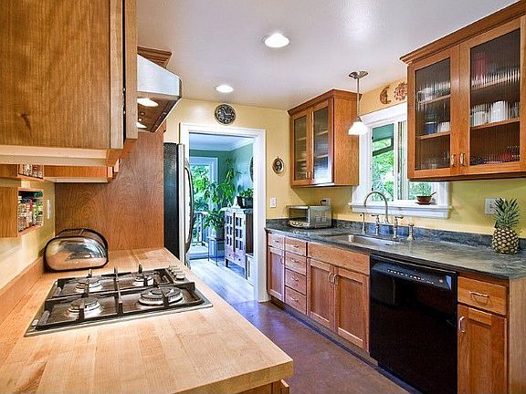 Remodeled kitchen with stylish venetian plaster counter tops and floor.
