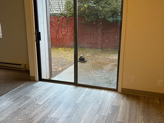 Dining with sliding door to private, fenced patio.