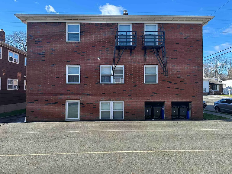 Back of Building, showing parking spaces. Rent includes off-street assigned parking for 2 non-commercial cars (in tandem).