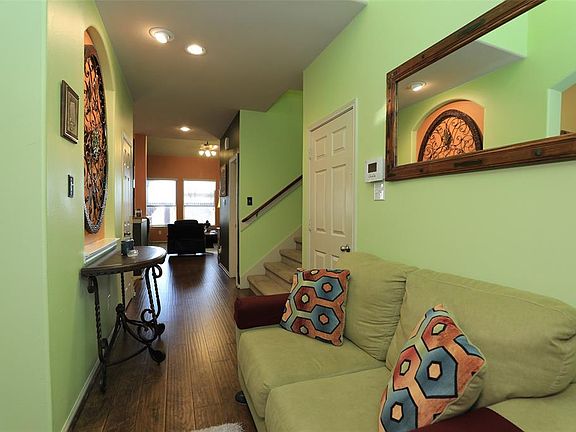 Open entryway leads to formal dining, garage access, and hall to stairs/living area