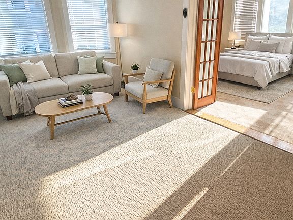 Living room with large bay windows (AI Staged)