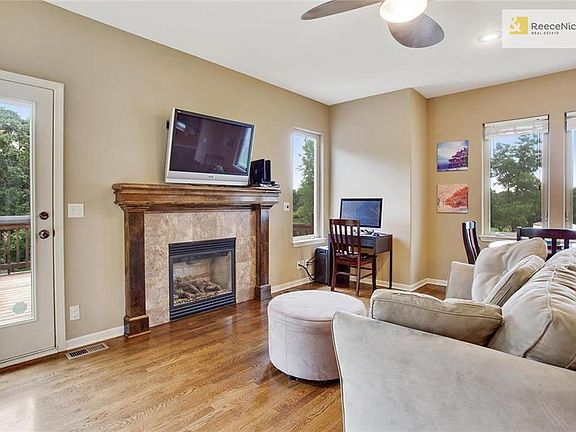 Walking into the hearthroom, I can't keep my eyes off the view.  These hardwood floors and the fireplace are so inviting. A cozy place in the winter and the door to the deck for a place to relax and unwind in the other seasons. A vacation home in the city.