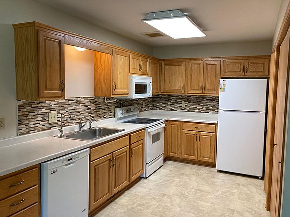 Kitchen with newer appliances including dishwasher and microwave