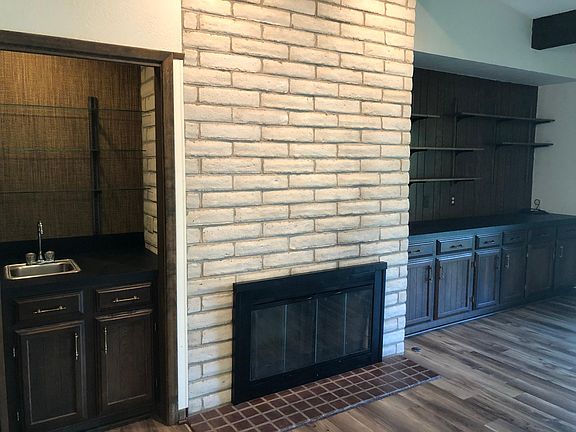 Wet bar, decorative fireplace, wall of built-ins