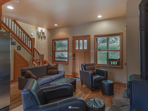 Beautiful hardwood floors, living space with  open concept design. Beautiful views out the front window & wood stove for that comfy warm cabin home living.