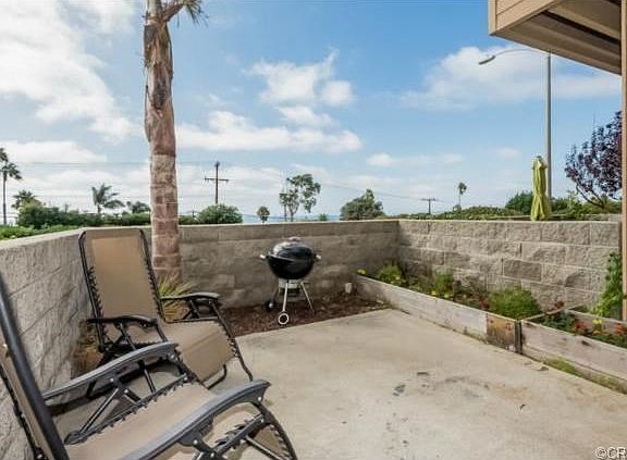 Private patio off of the living room with planters and ocean vie