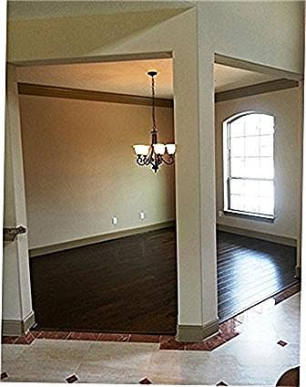  Great view of your large formal dining area with rich hardwoods and pass way through to the kitchen. Gorgeous design tile flooring in your entry.