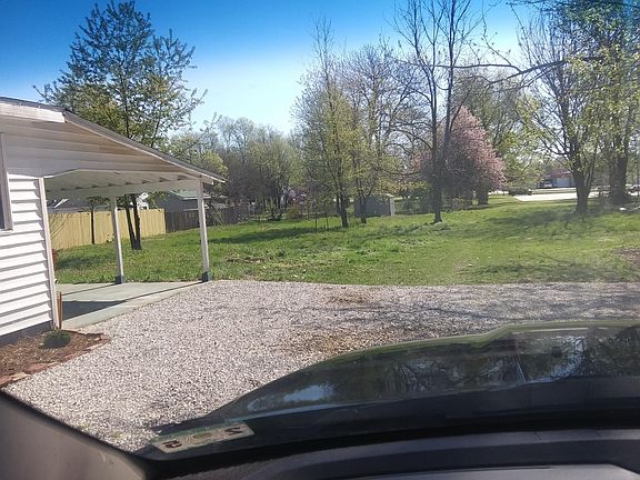 A view of the end of the driveway with the new rock. The backyard. The neighbor just installed a new fence, too!