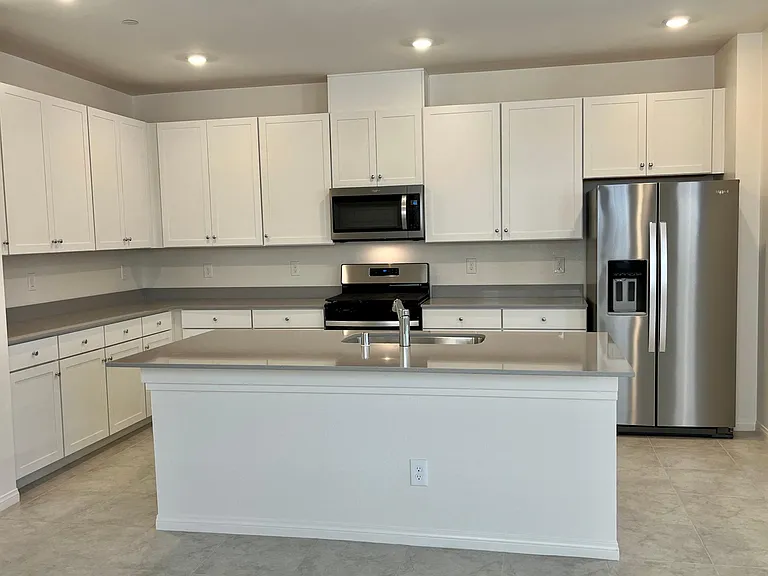 Kitchen wtih large quartz island and brand new, upgraded Whirlpool appliances!