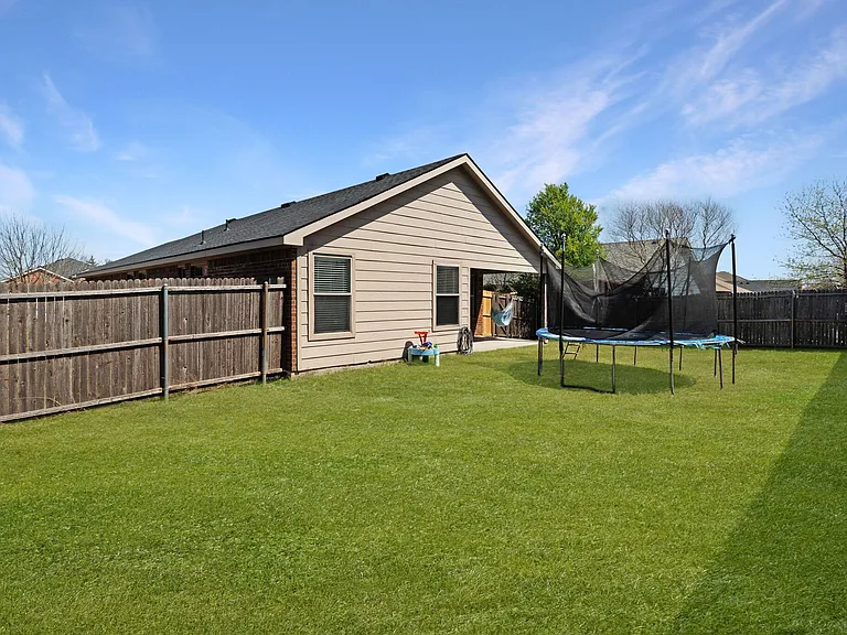 The large back yard provides plenty of room for a children's playset, a trampoline and even running room for a pet dog to run