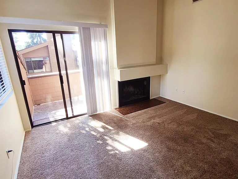 Living room w/ wood burning fireplace