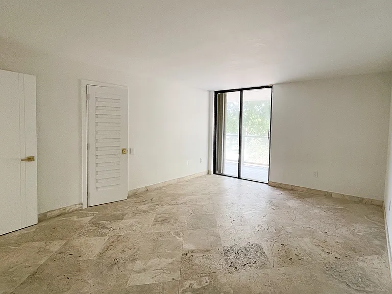 Guest bedroom with closet comfortably fits 2 twin beds and an office space and has its own access to the wrap around balcony.