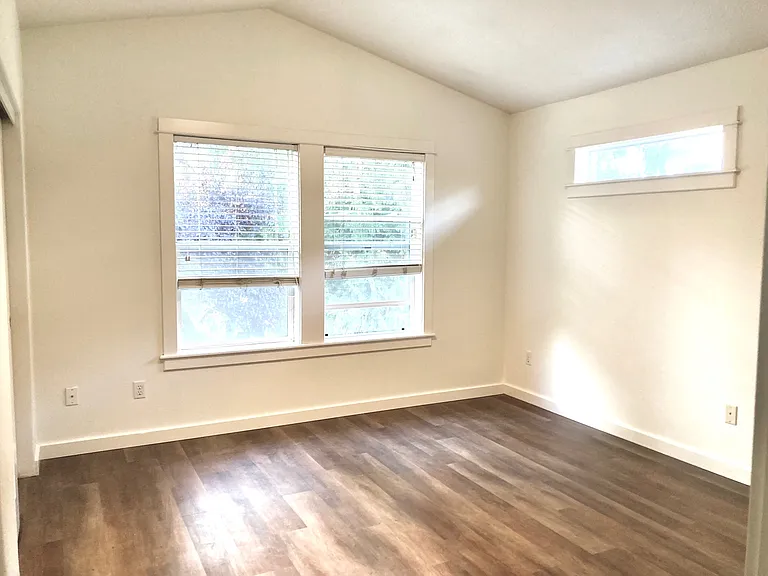 Same large primary bedroom- with new floors and fresh paint.