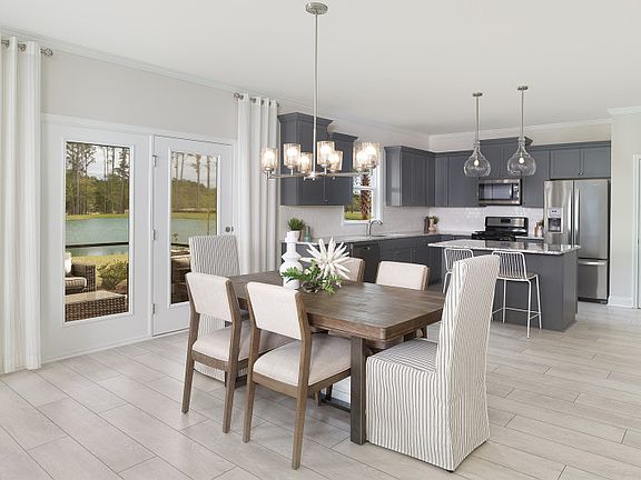 The dining area flows nicely into the kitchen and gathering room, making entertaining a breeze - Mod
