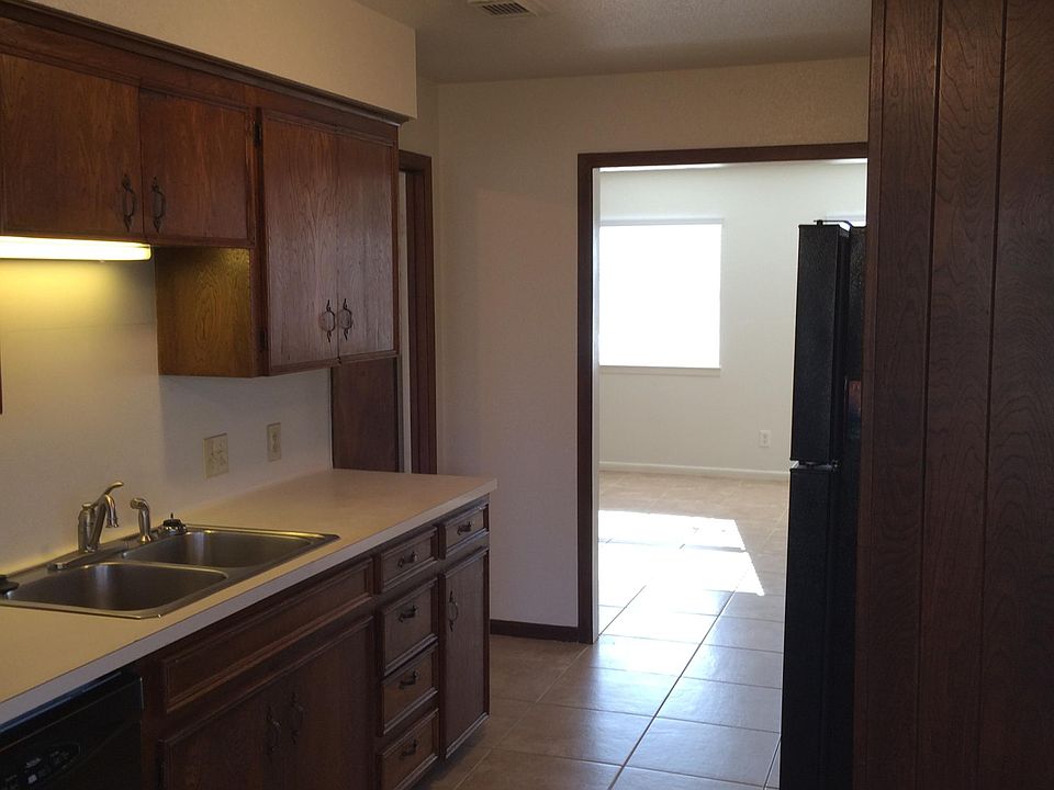 Kitchen and adjoining living room entry as seen from breakfast area as you enter from the covered back porch.