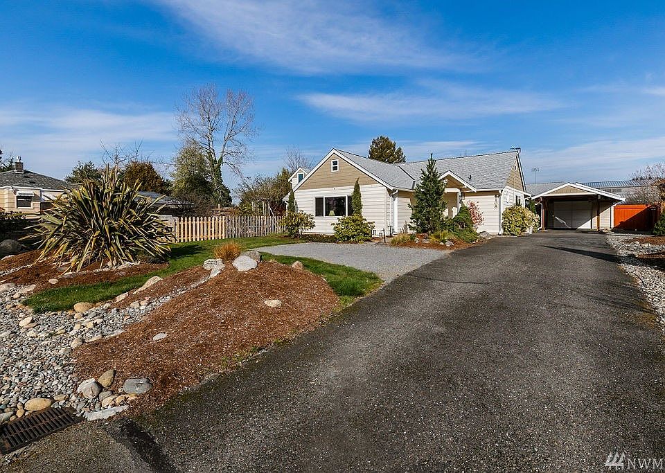 A long driveway, offering abundant parking space, leads to this desirable sprawling rambler.