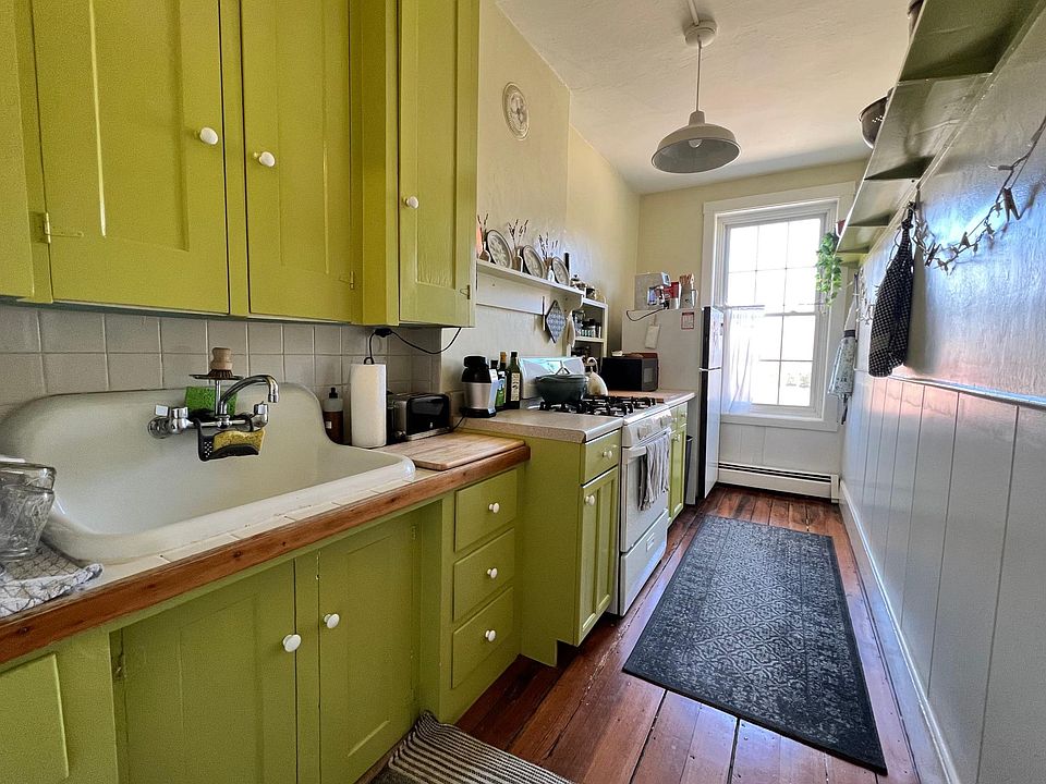 Galley Kitchen with wide vintage porcelain sink and original cabinets