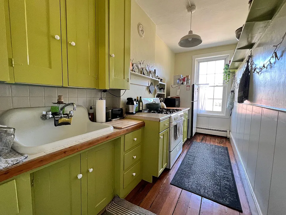 Galley Kitchen with wide vintage porcelain sink and original cabinets