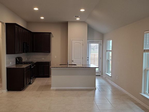 View of the entire kitchen and back door.